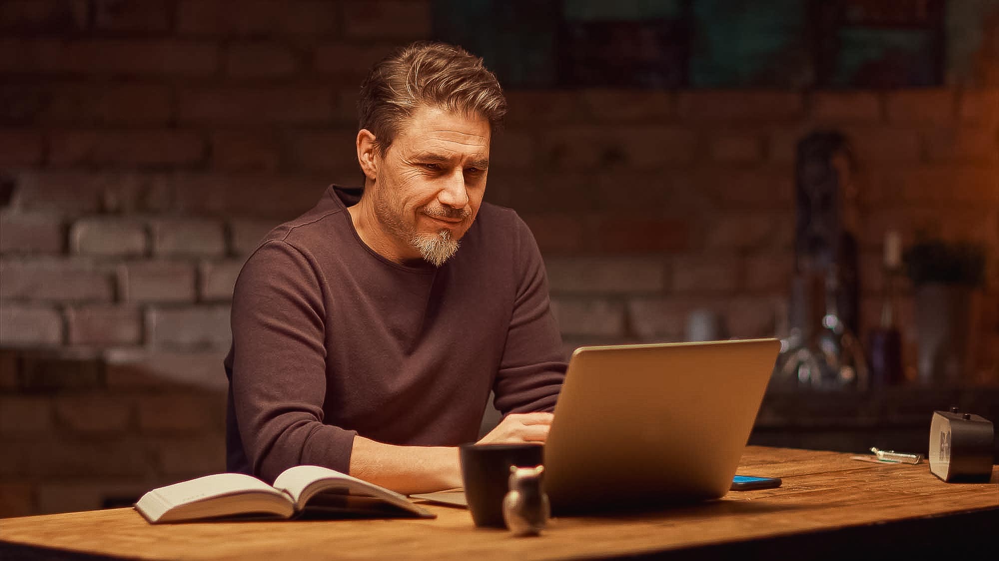 Man working with laptop computer at home office