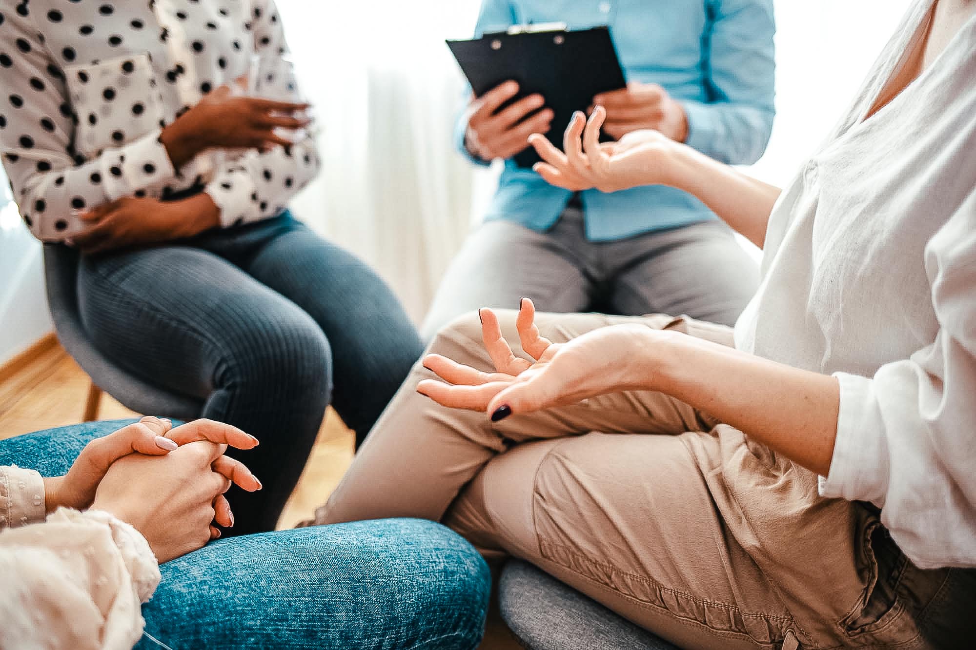 Unrecognizable vulnerable woman participates in group therapy se